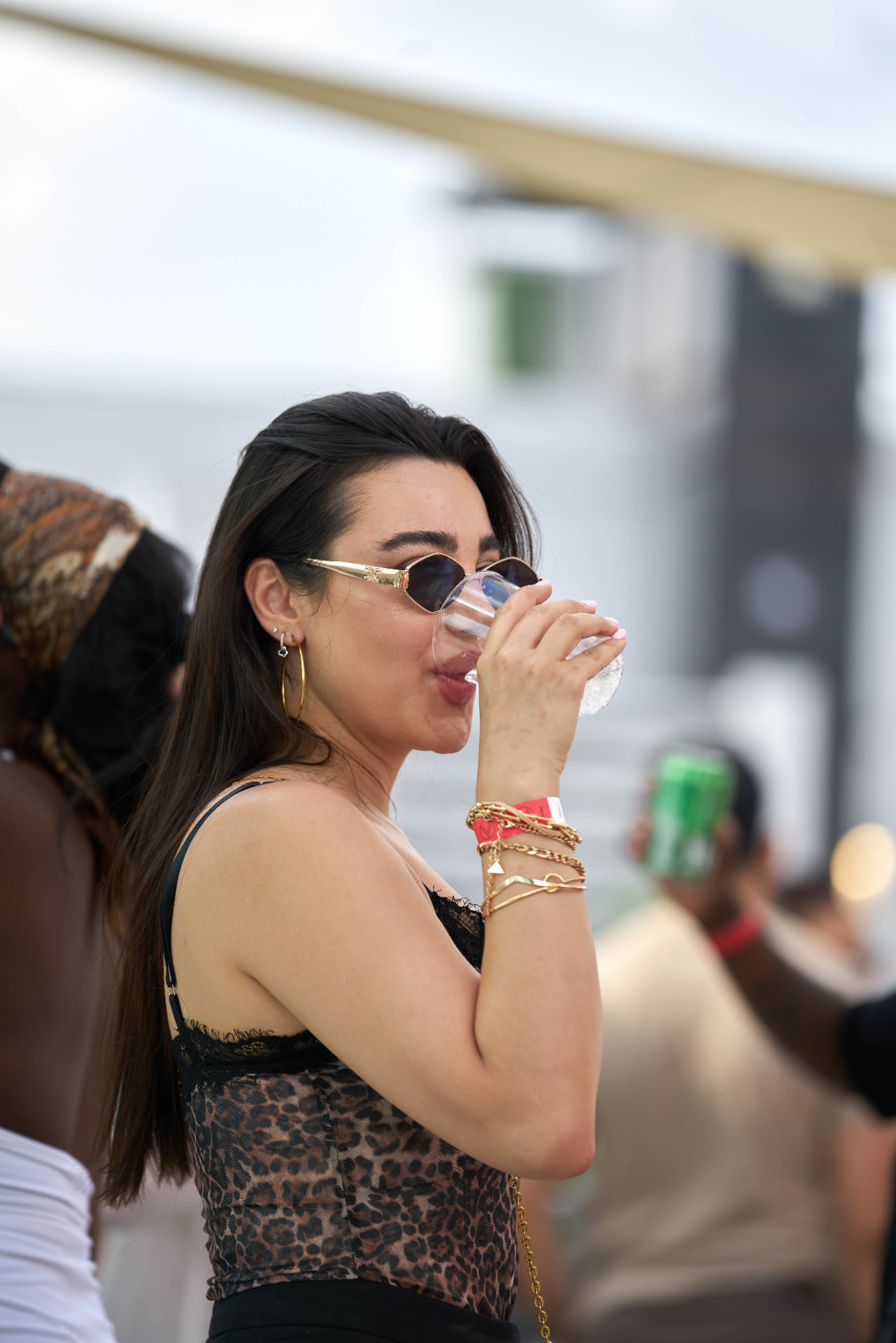 Guest in sunglasses sipping a drink in the afternoon light on the terrace