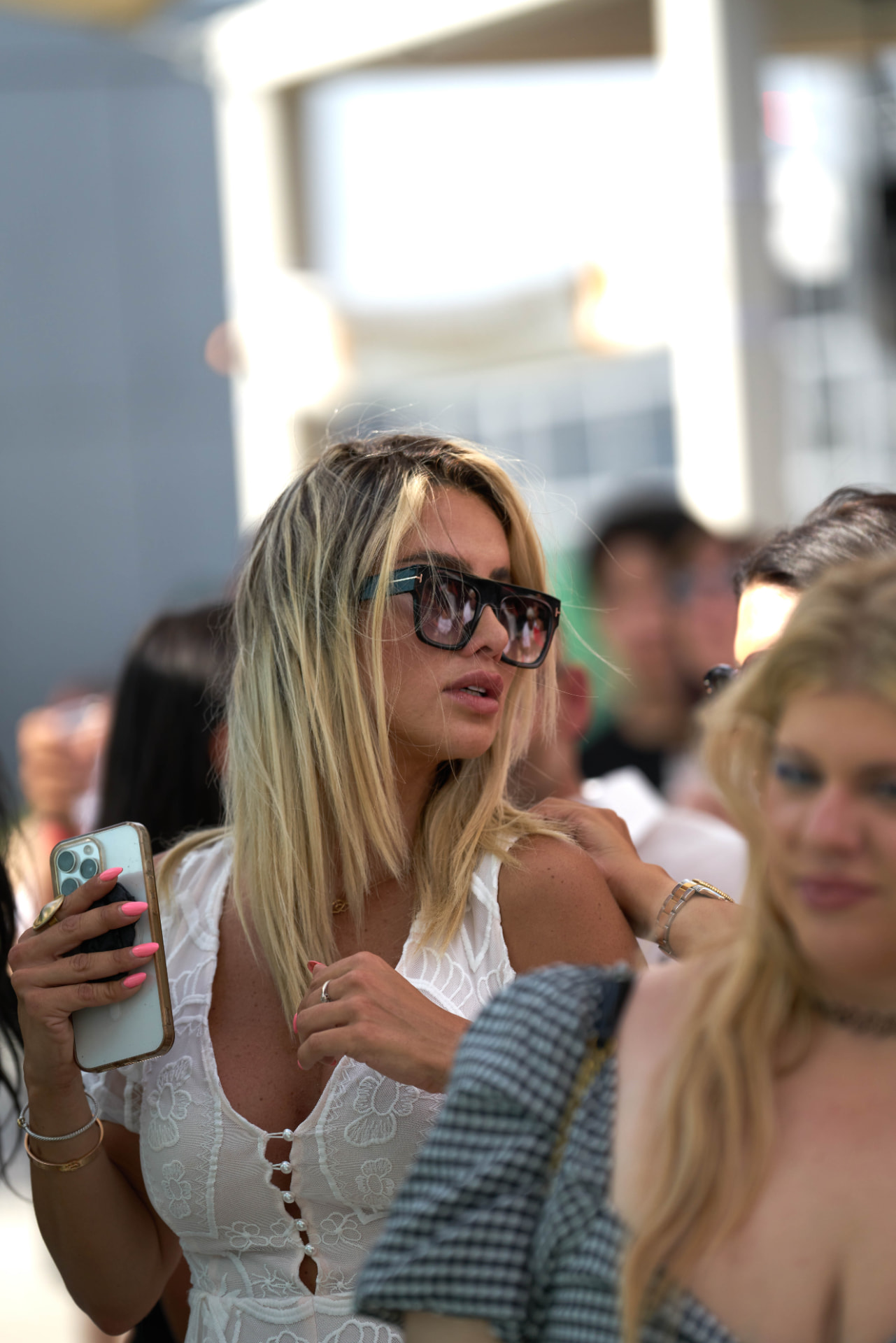 Guests in white against the bright rooftop backdrop during the daytime set